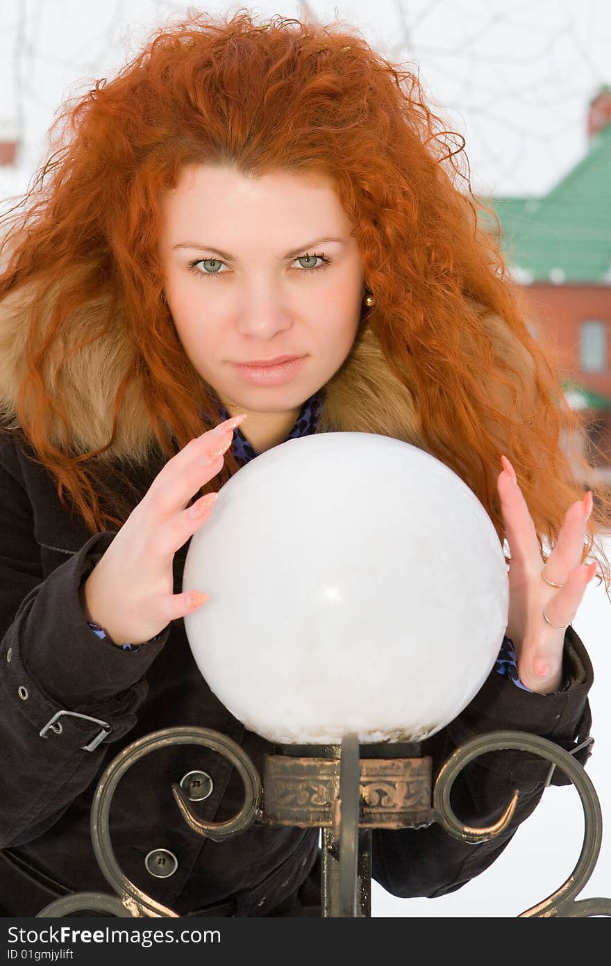 Beautiful red hair witch is practicing with sphere. Beautiful red hair witch is practicing with sphere