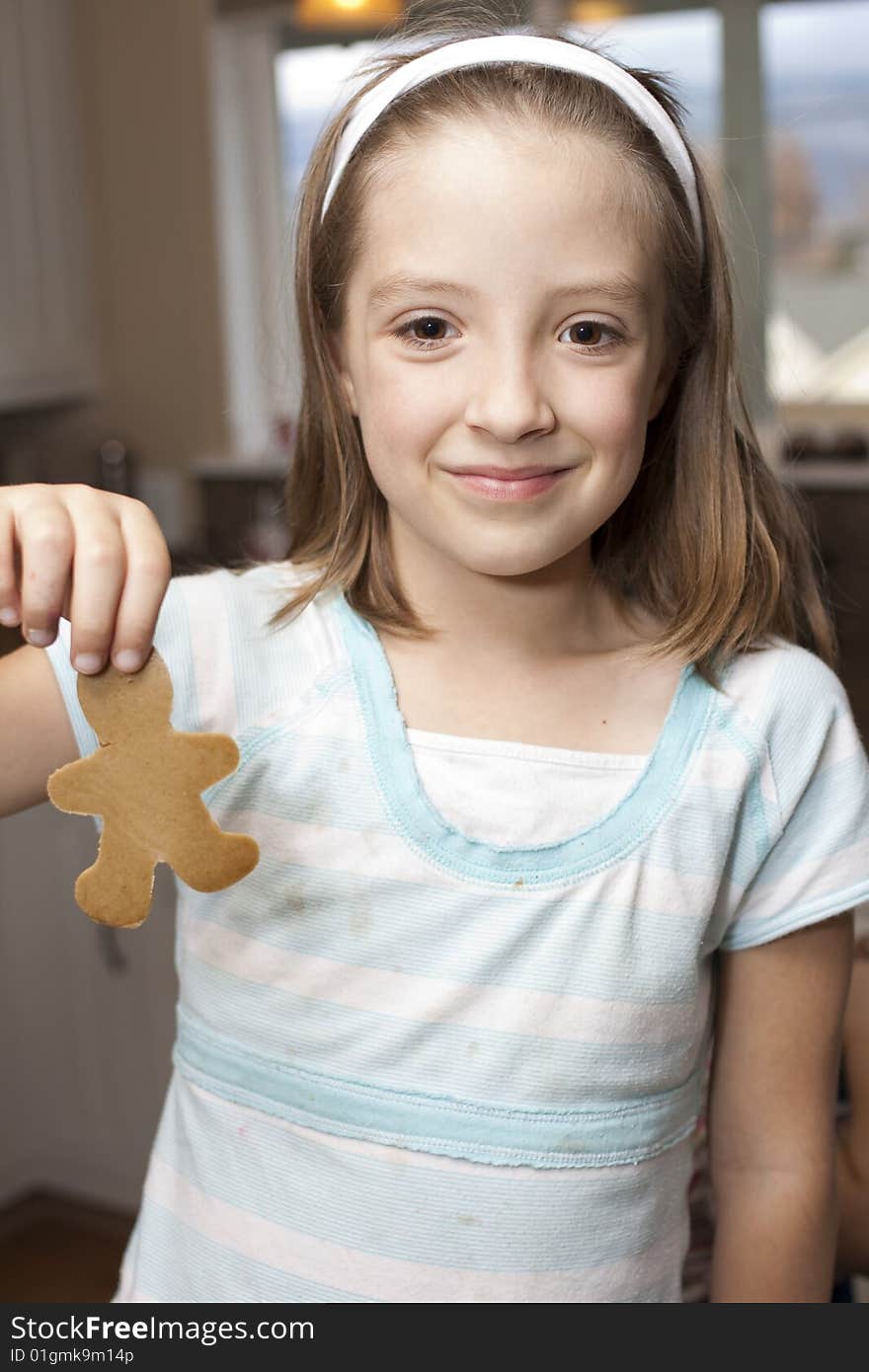 Nine year old girl shows her gingerbread cookie. Nine year old girl shows her gingerbread cookie.