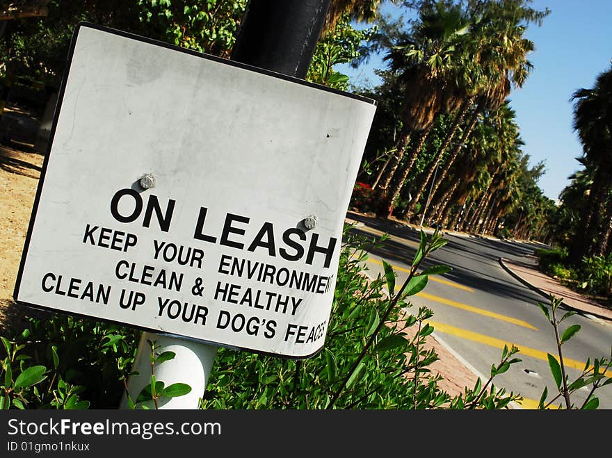 Keep your dog on leash and clean up its feaces sign. Keep your dog on leash and clean up its feaces sign