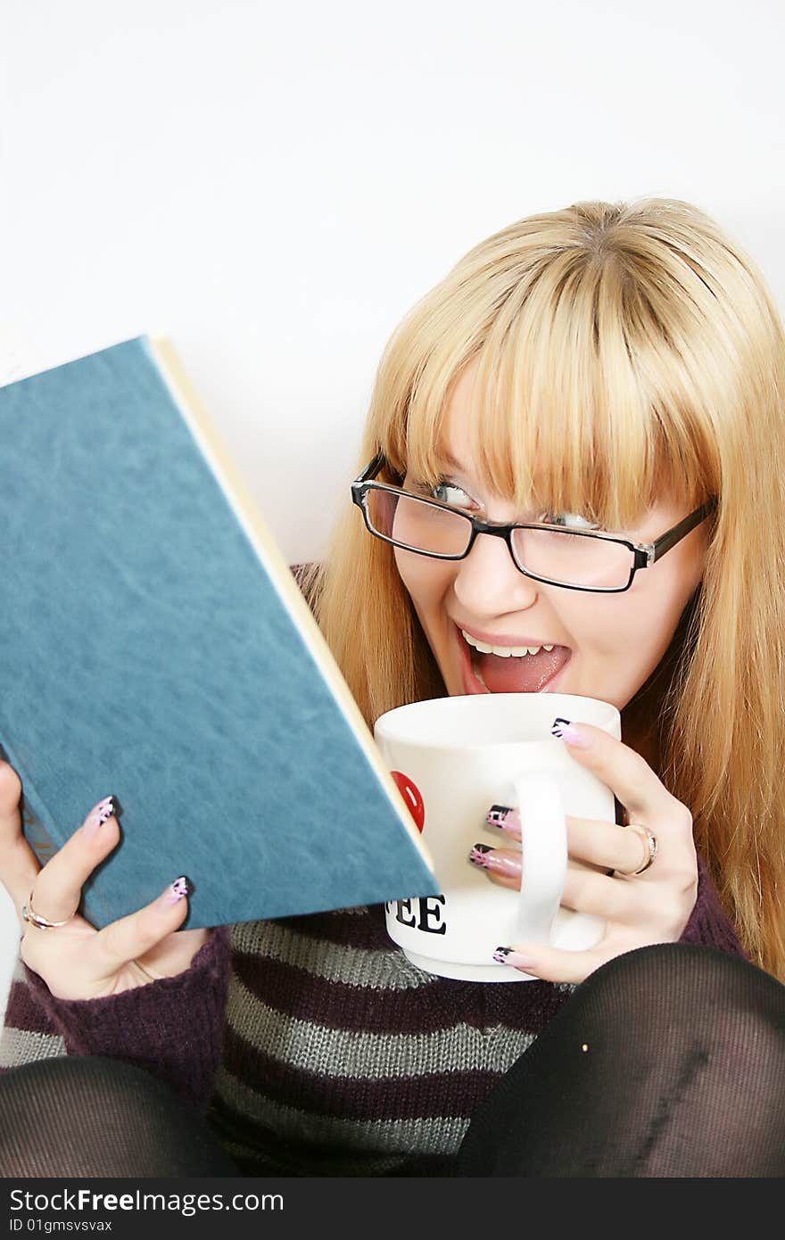 Portrait of a  young lady reading a book and saile  with  cup in hand. . Isolated over white background. Portrait of a  young lady reading a book and saile  with  cup in hand. . Isolated over white background