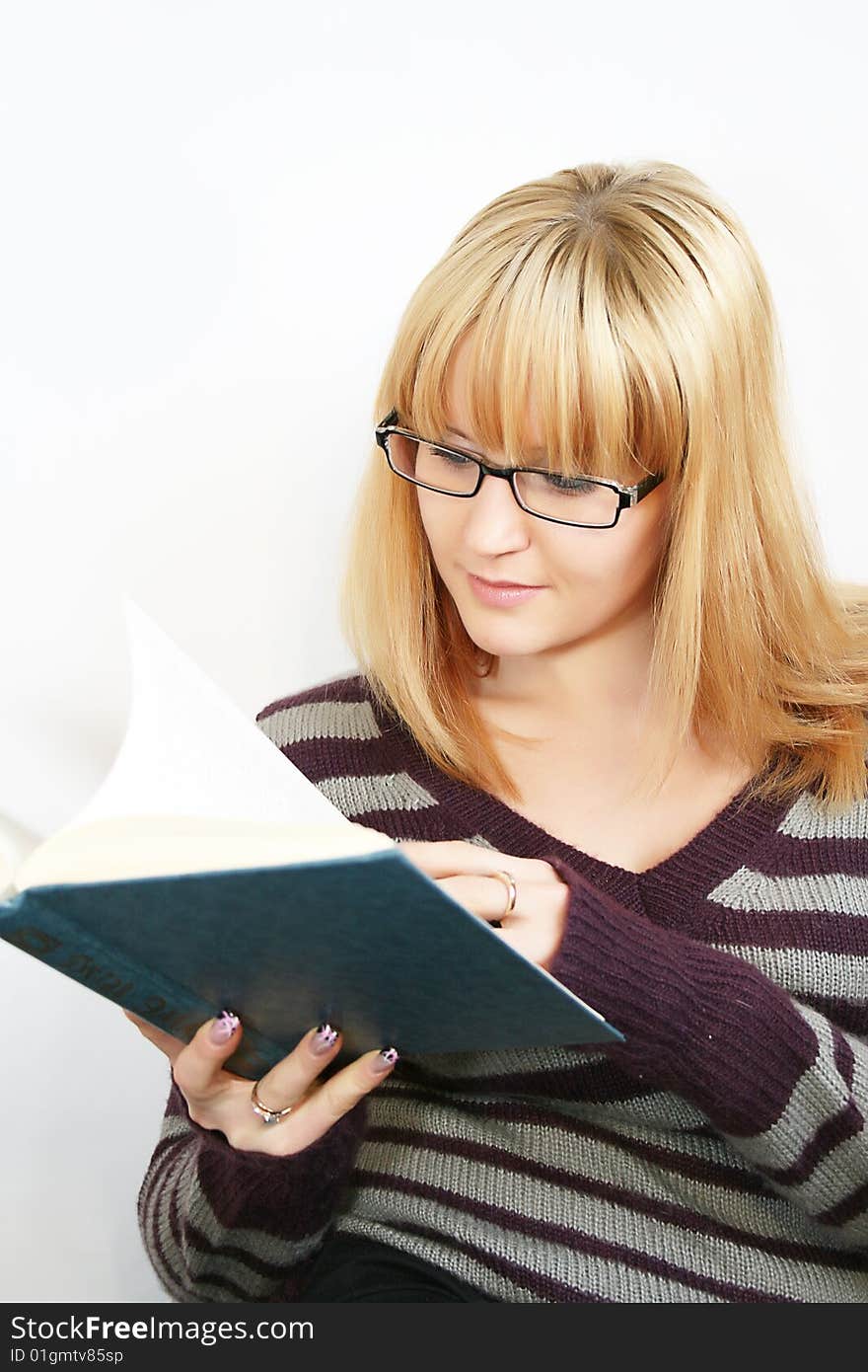 Portrait of a  young lady reading a book and saile  with  cup in hand. . Isolated over white background. Portrait of a  young lady reading a book and saile  with  cup in hand. . Isolated over white background