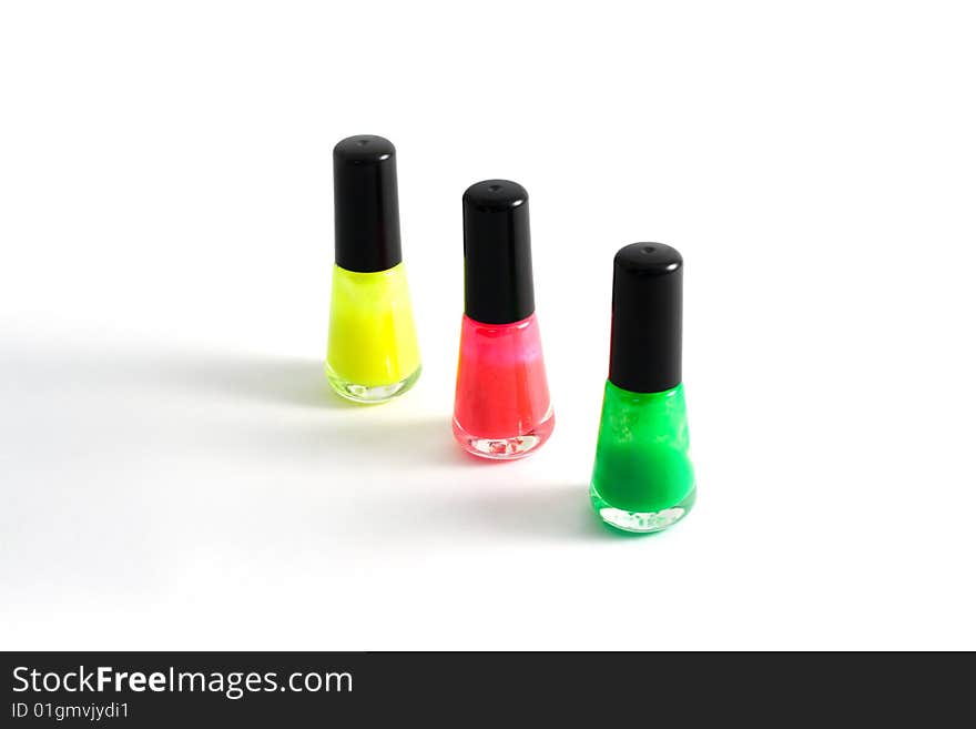 Three vials of the colour varnish for nail on white background