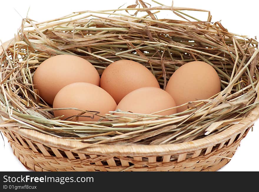 Chicken Eggs In The Brown Basket And Hay.