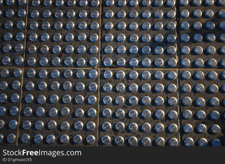 Pavement tiles with steel studs