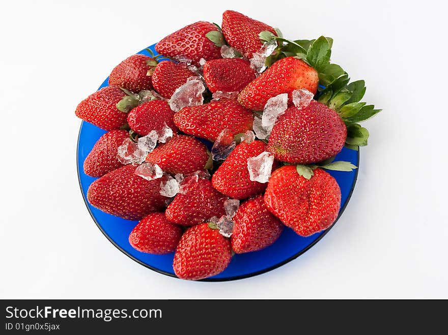 Blue plate with strawberries and ice. Blue plate with strawberries and ice