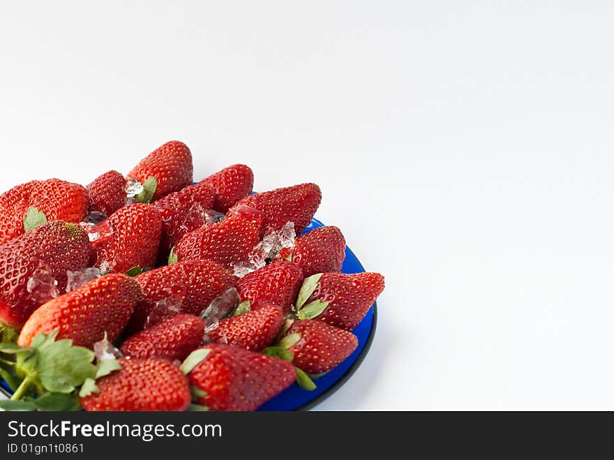 Blue plate with strawberries and ice. Blue plate with strawberries and ice