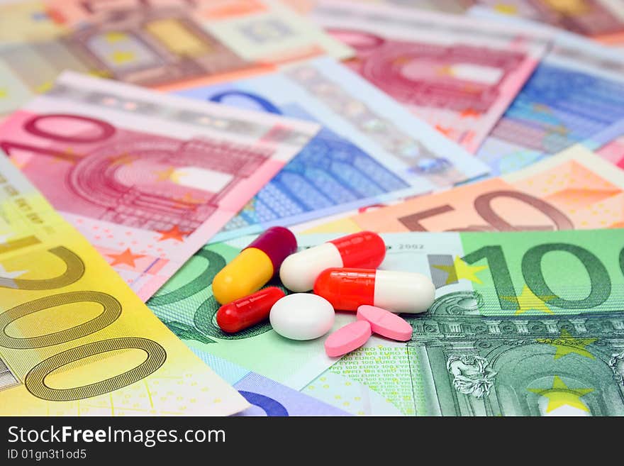 Assorted pills and capsules over euro money. Assorted pills and capsules over euro money