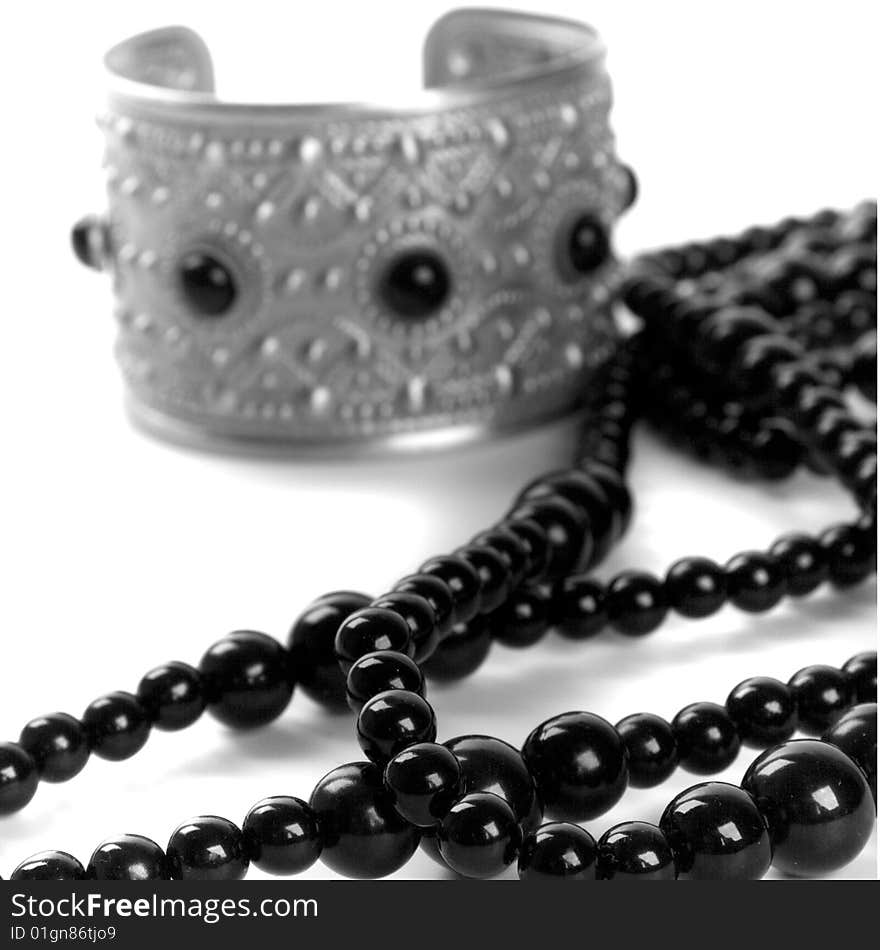 Bracelet and black necklace closeup on a white background. Bracelet and black necklace closeup on a white background