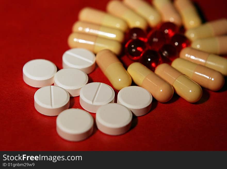 Vitamines in red and white tablets in close up