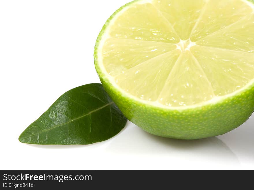 Green lime with leaf isolated on white