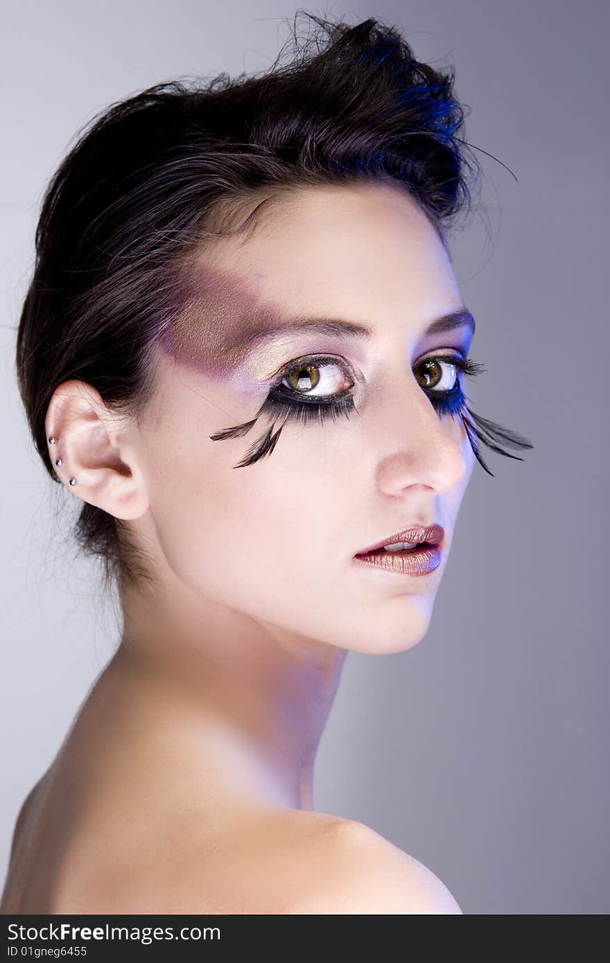 Attractive young lady with extravegant makeup and eyelashes