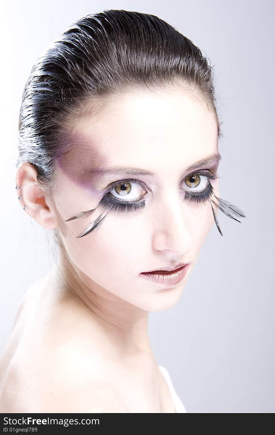 Attractive young lady with extravegant makeup and eyelashes