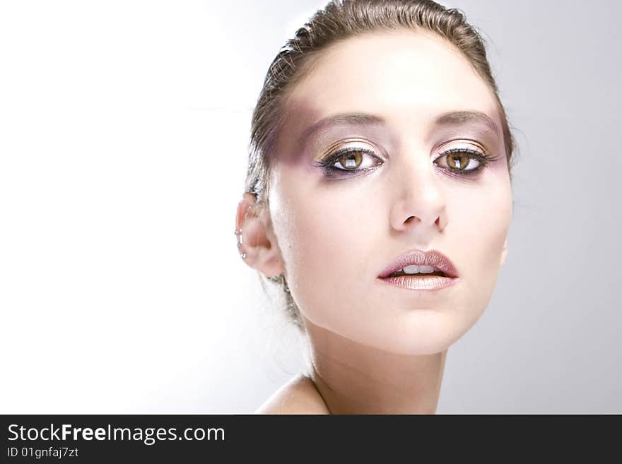 Attractive young lady with extravegant makeup and black eyelashes black and white background with some gray