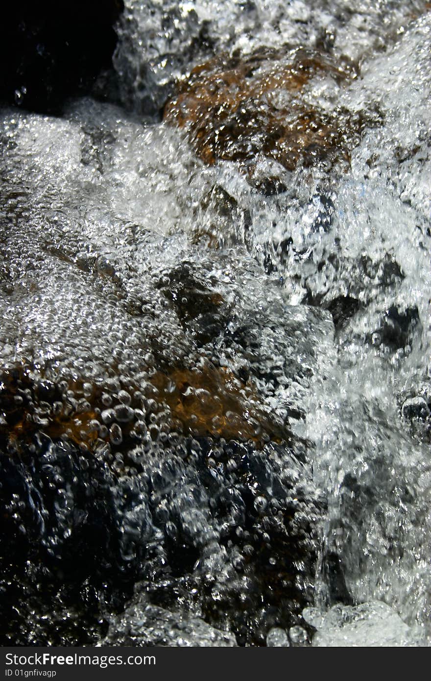 Water stream with bubbles in Carpathian mountains