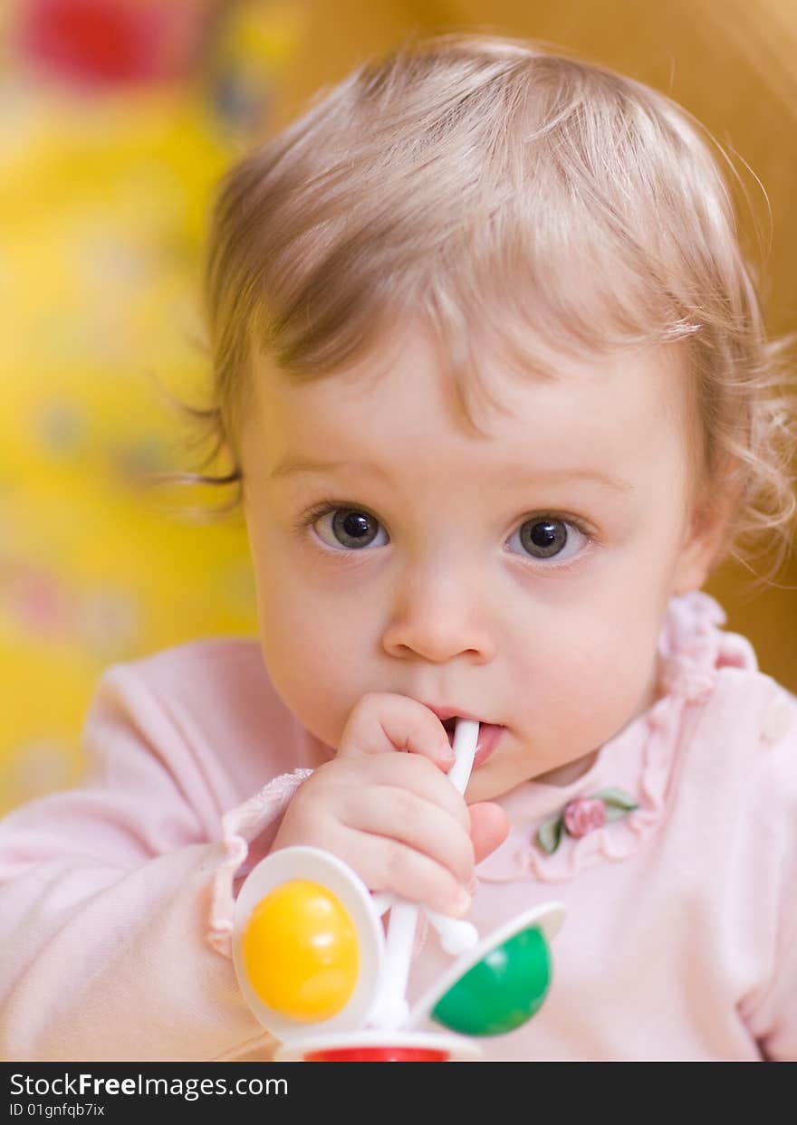 Little girl playing with rattle - shallow DOF