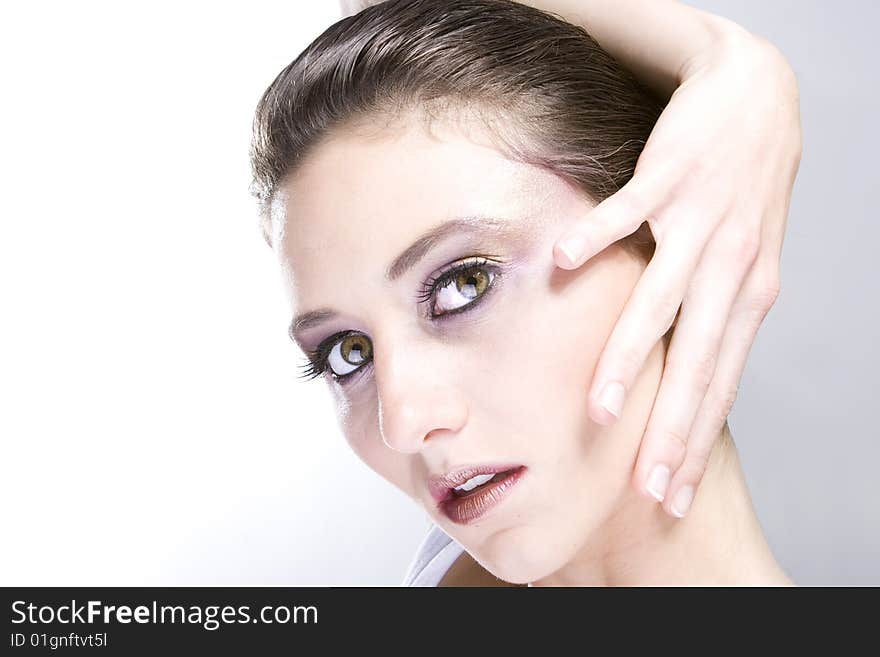 Attractive young lady with extravegant makeup and black eyelashes black and white background with some gray