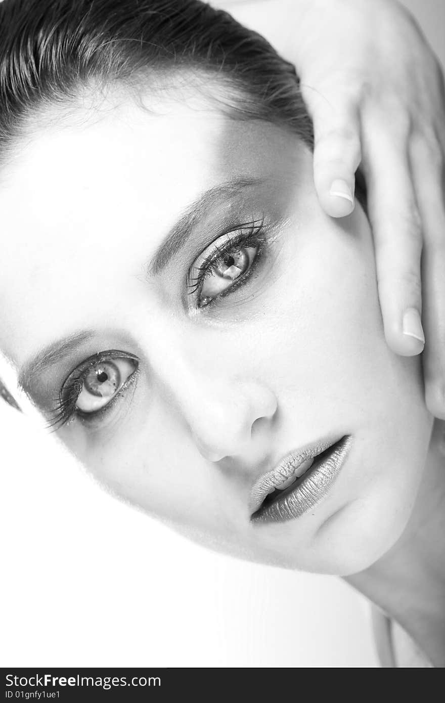 Attractive young lady with extravegant makeup and black eyelashes black and white background with some gray