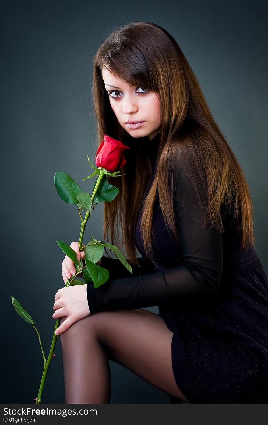 Young girl with rose, studio shot