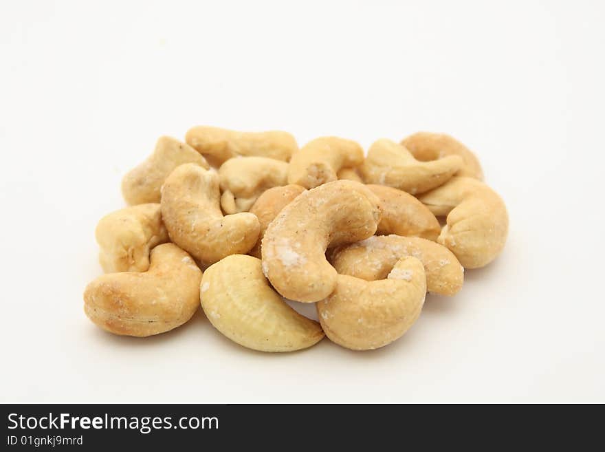 Salted indian walnuts on white background