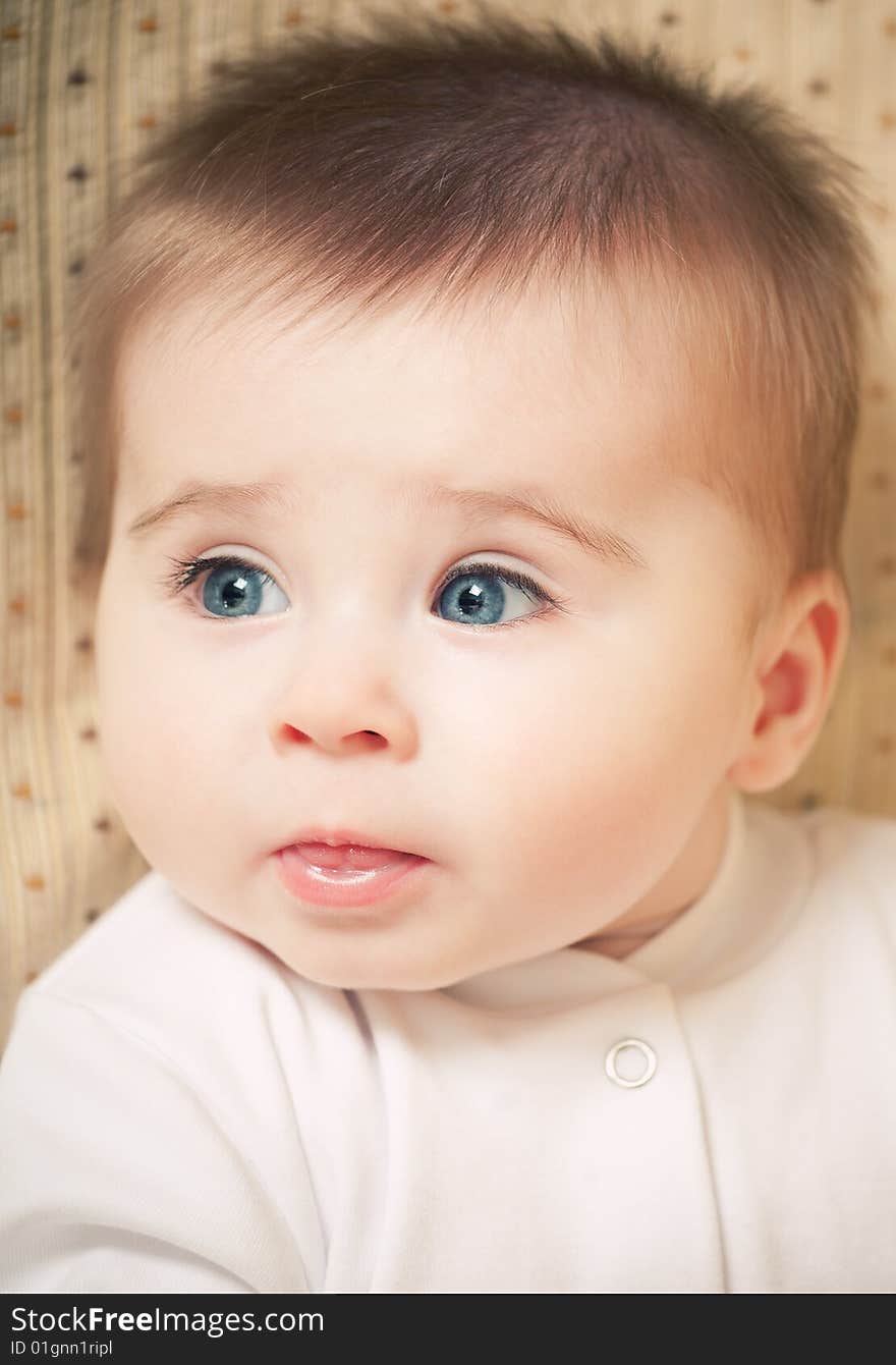 Portrait of adorable blue-eyes baby. Face close-up