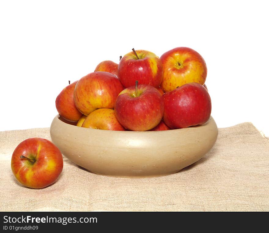 An isolated pottery bowl filled with fresh delicious ripe apples. An isolated pottery bowl filled with fresh delicious ripe apples