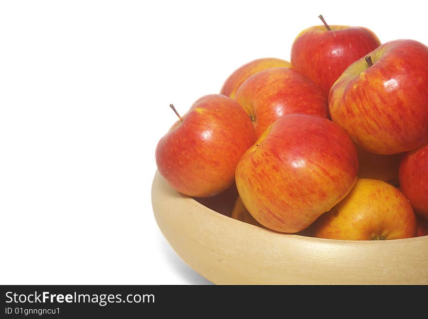 An isolated pottery bowl filled with fresh delicious ripe apples. An isolated pottery bowl filled with fresh delicious ripe apples