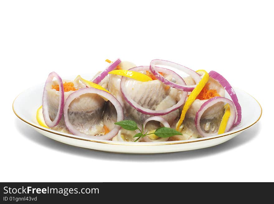 Herrings with vegetables on the plate isolated. Herrings with vegetables on the plate isolated