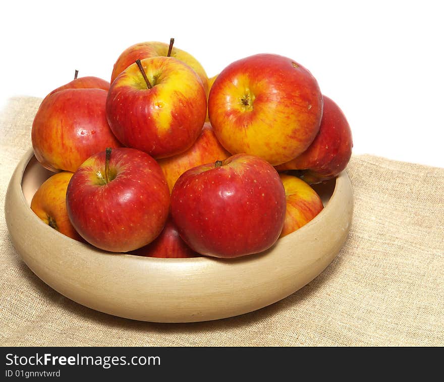 An isolated pottery bowl filled with fresh delicious ripe apples. An isolated pottery bowl filled with fresh delicious ripe apples