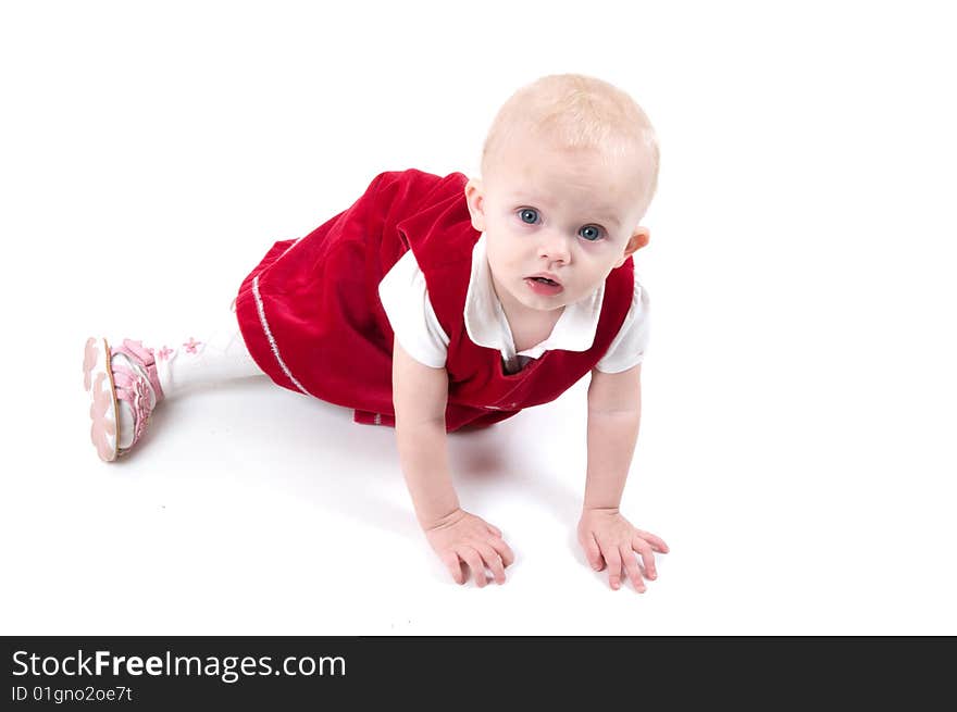 Baby in red is sitting on the floor. Baby in red is sitting on the floor