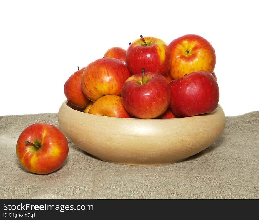 An isolated pottery bowl filled with fresh delicious ripe apples. An isolated pottery bowl filled with fresh delicious ripe apples