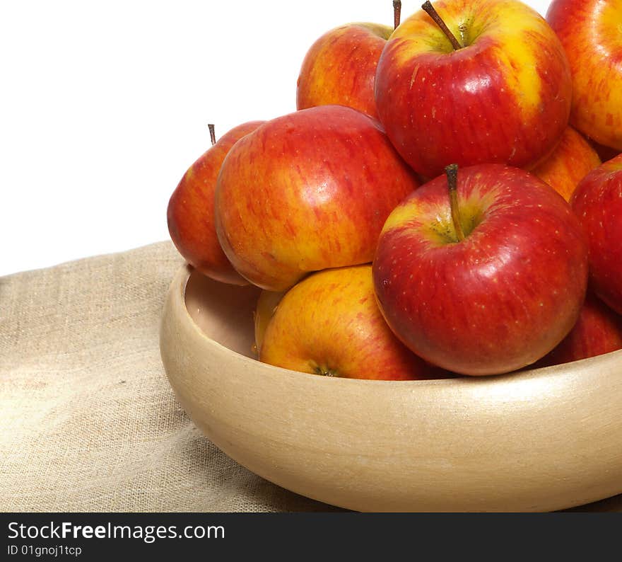 An isolated pottery bowl filled with fresh delicious ripe apples. An isolated pottery bowl filled with fresh delicious ripe apples