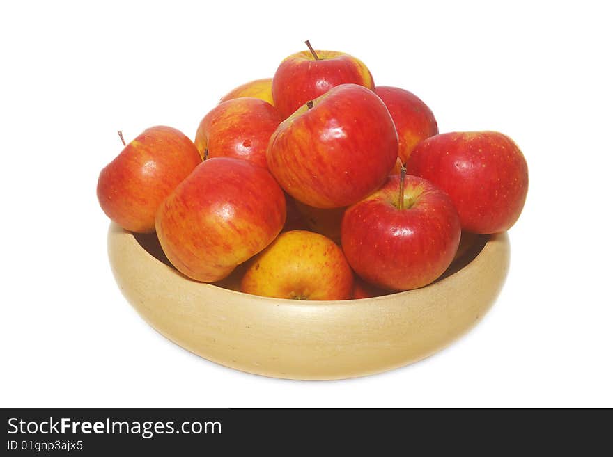 An isolated pottery bowl filled with fresh delicious ripe apples. An isolated pottery bowl filled with fresh delicious ripe apples