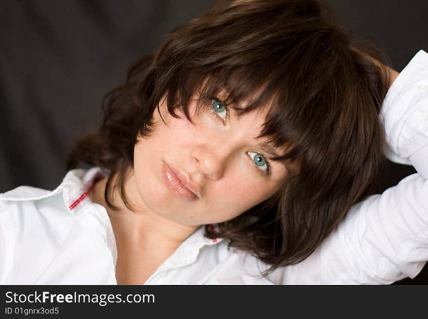 Portrait of a girl with chestnut hair on a black background. Portrait of a girl with chestnut hair on a black background