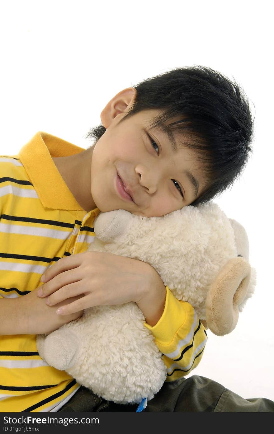 Happy boy cuddling a soft toy sheep. Happy boy cuddling a soft toy sheep