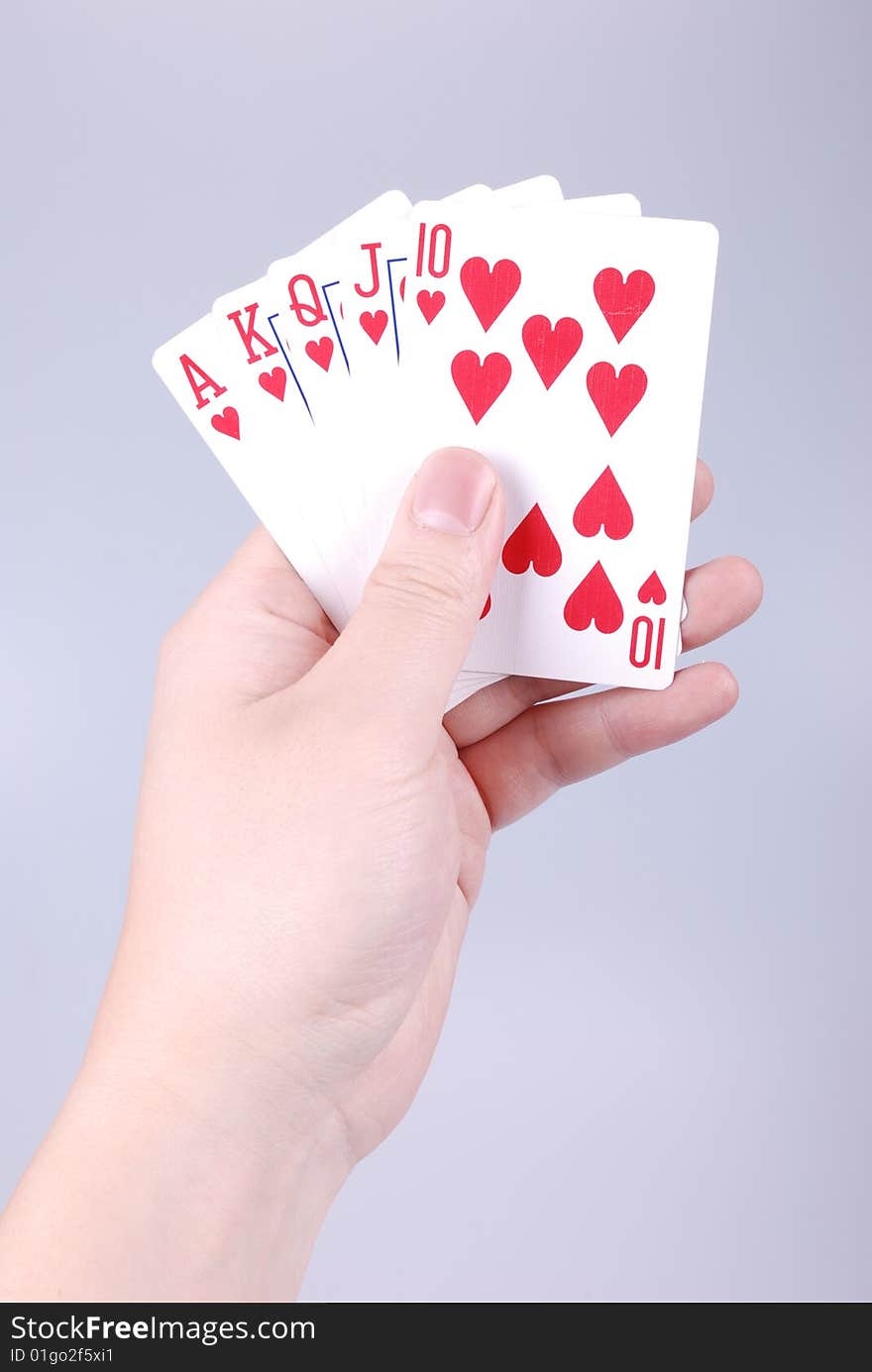 Poker in a hand with gray background. Poker in a hand with gray background