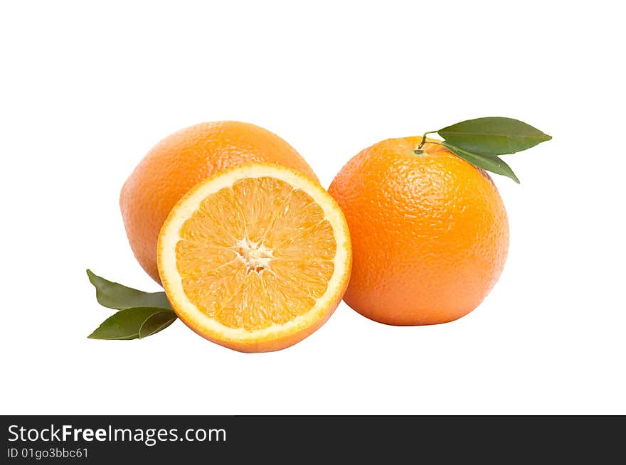 Ripe,juicy oranges and green leaves isolated on a white background. Ripe,juicy oranges and green leaves isolated on a white background.