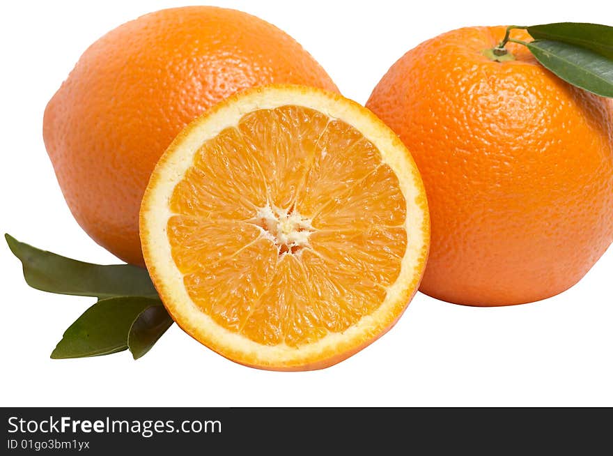 Juicy,ripe oranges and green leaves isolated on a white background. Juicy,ripe oranges and green leaves isolated on a white background.