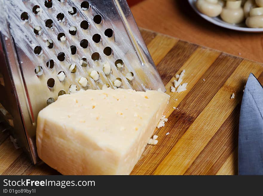 Stock photo: an image of food in the kitchen: mushrooms and cheese, grater