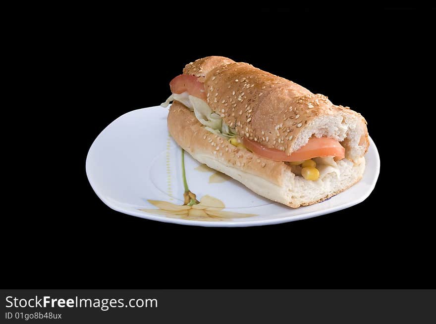 Baguette sandwich on plate, black background