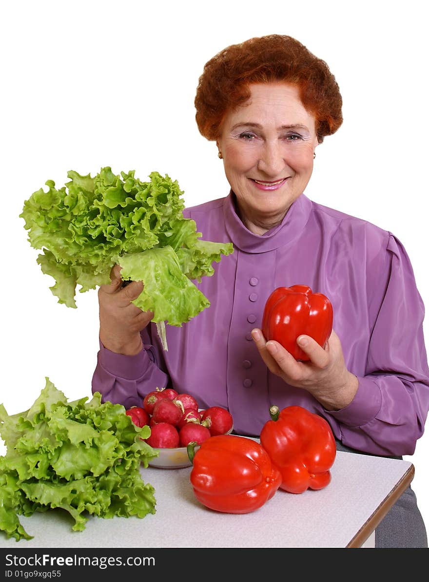 The woman is pleased to fresh vegetables on a white background. The woman is pleased to fresh vegetables on a white background