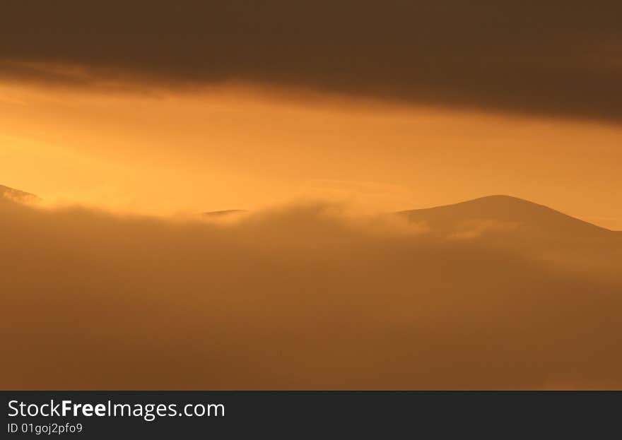 Beautiful orange sunset over the Malvern Hills, Worcestershire, England, UK. Beautiful orange sunset over the Malvern Hills, Worcestershire, England, UK