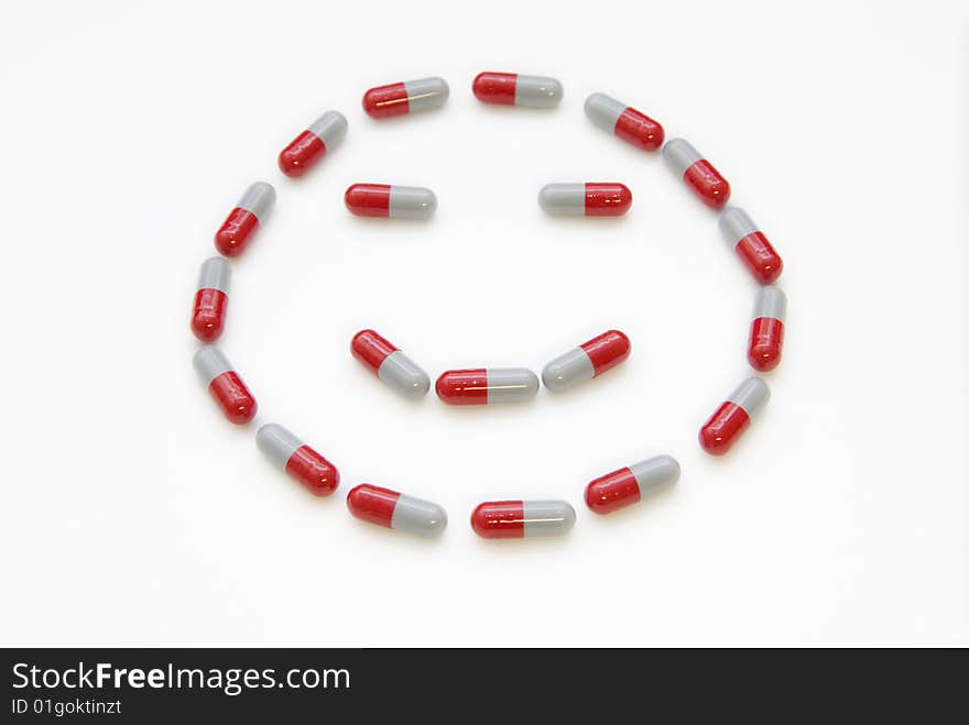 The pill constitute a smile face on white. The pill constitute a smile face on white