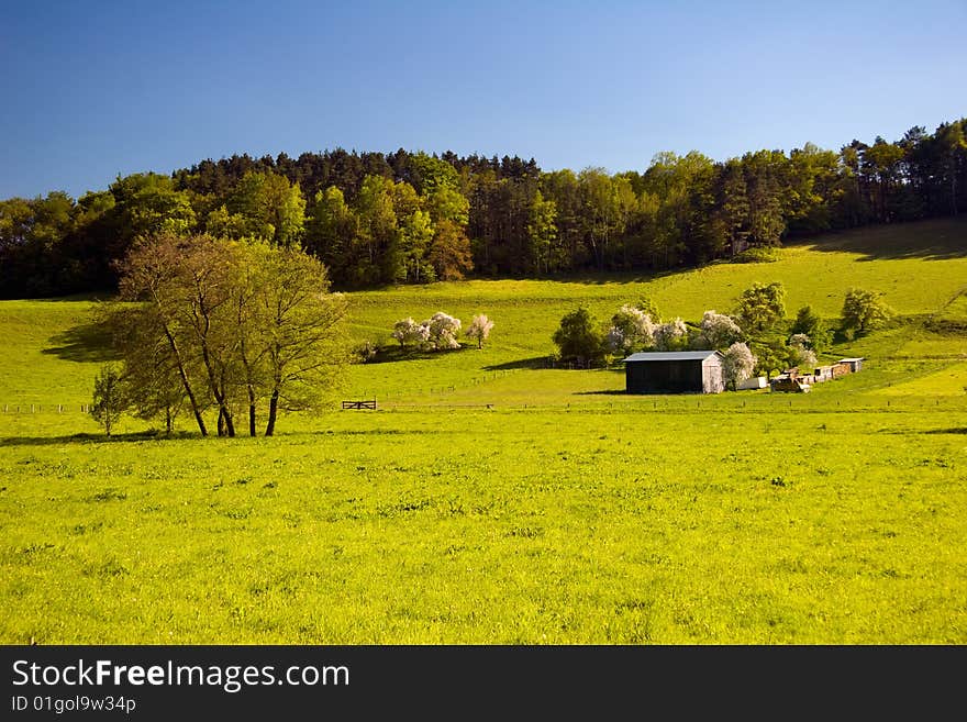 Summer Landscape with wooden agriculture Barn