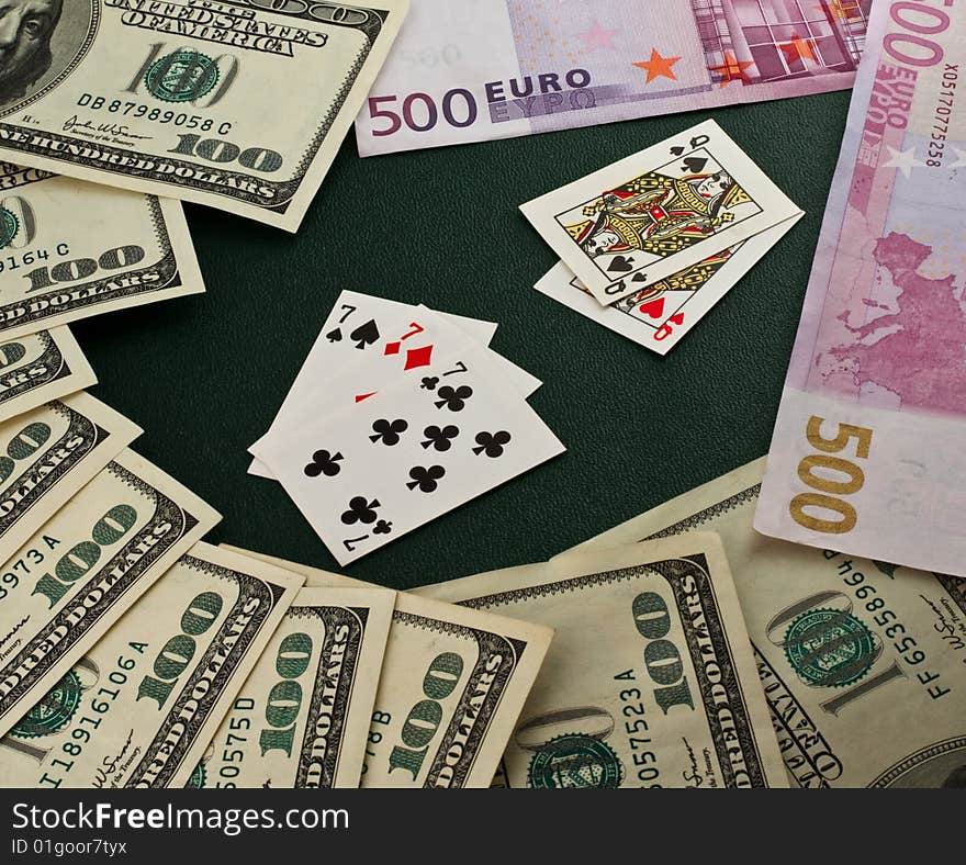 Playing cards, euro and dollars on a green background. Playing cards, euro and dollars on a green background