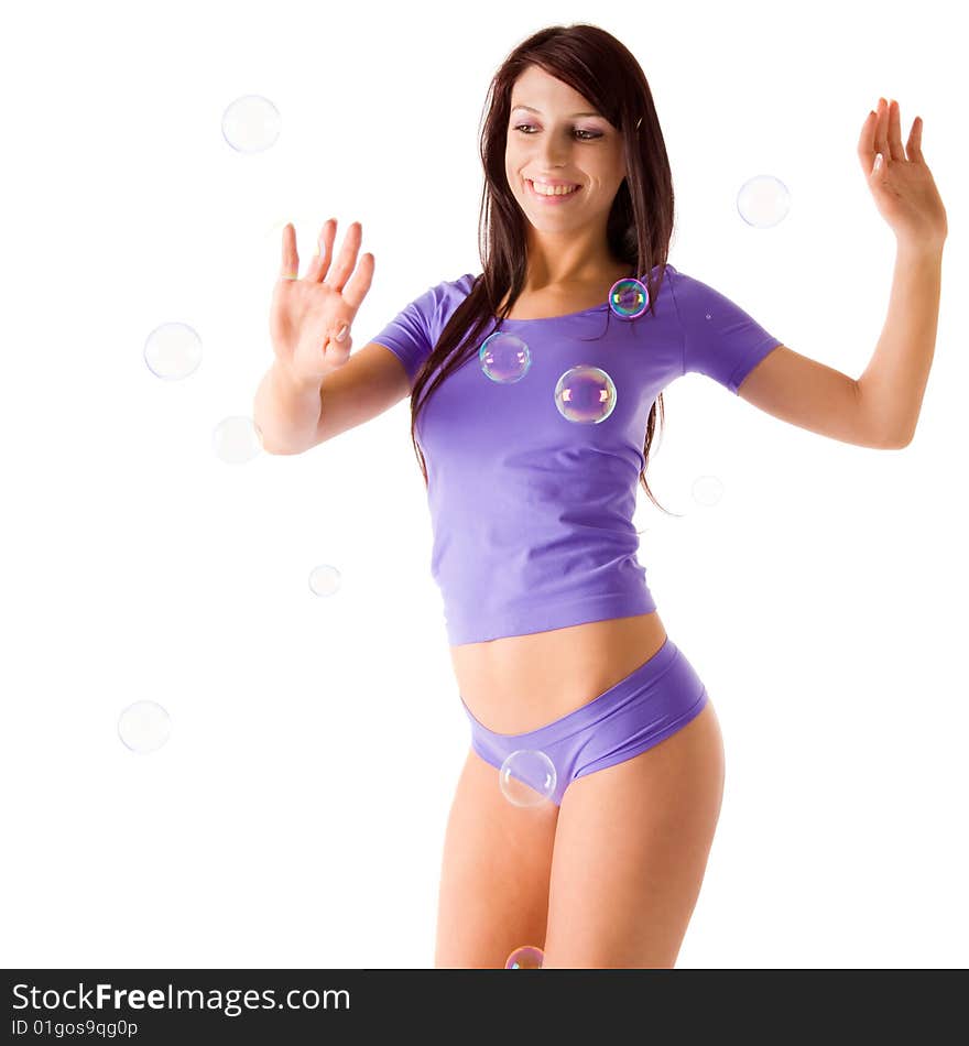 Smiling girl playing with soap bubbles