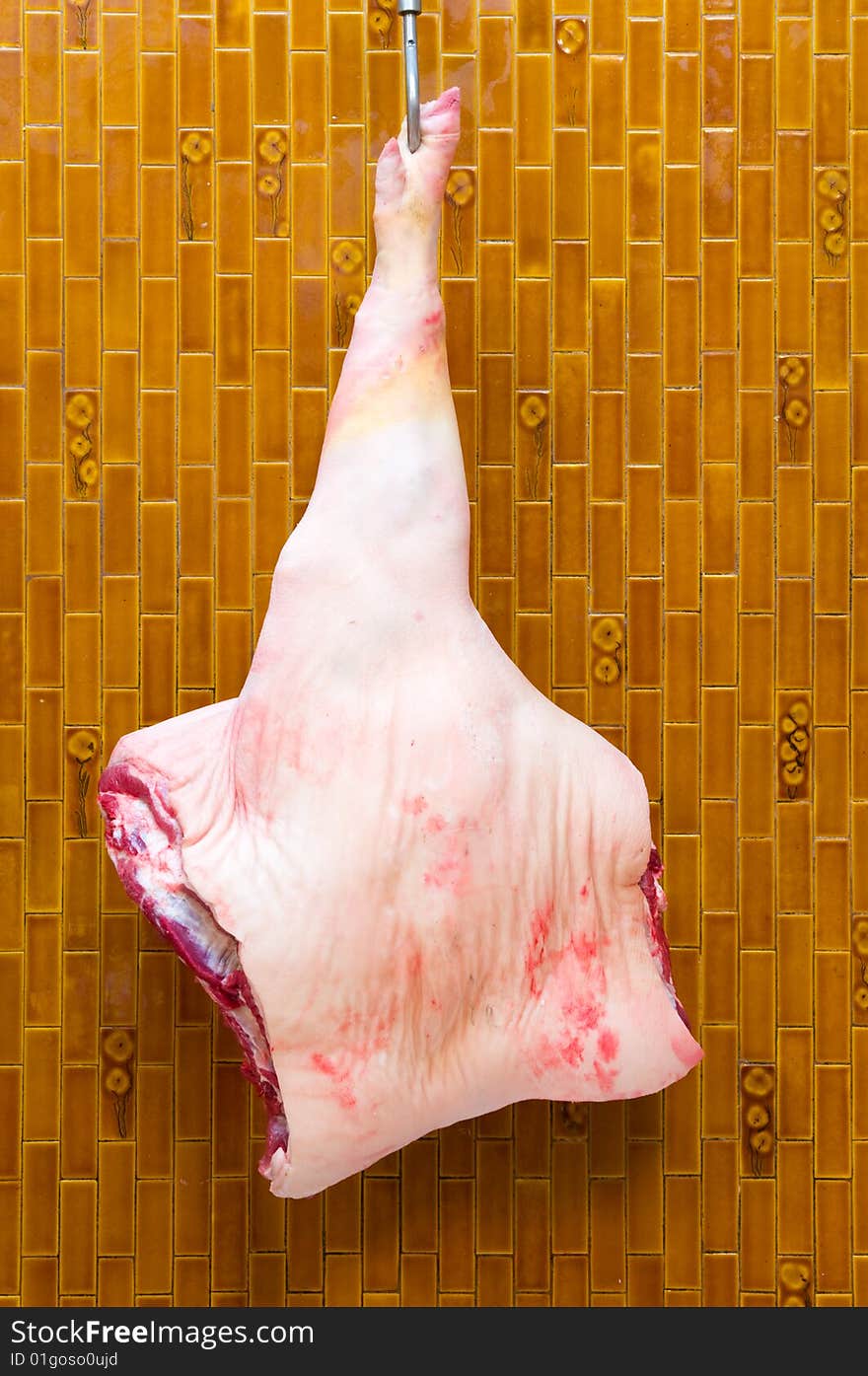 Fore leg of Italian pork. Forequarter of pork attached to a hook