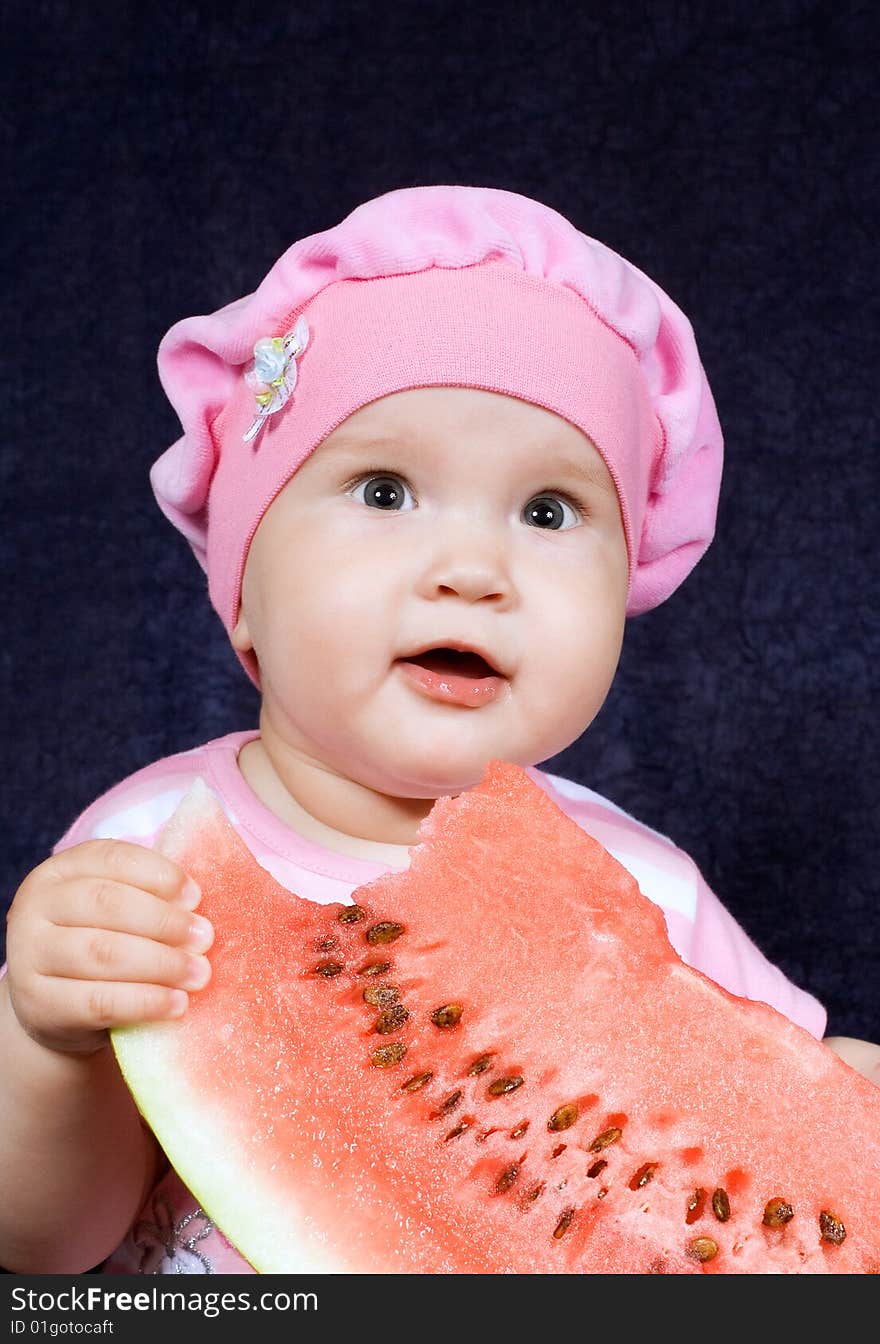 Child sits with red watermelon with pleasure his(its) eats. Child sits with red watermelon with pleasure his(its) eats