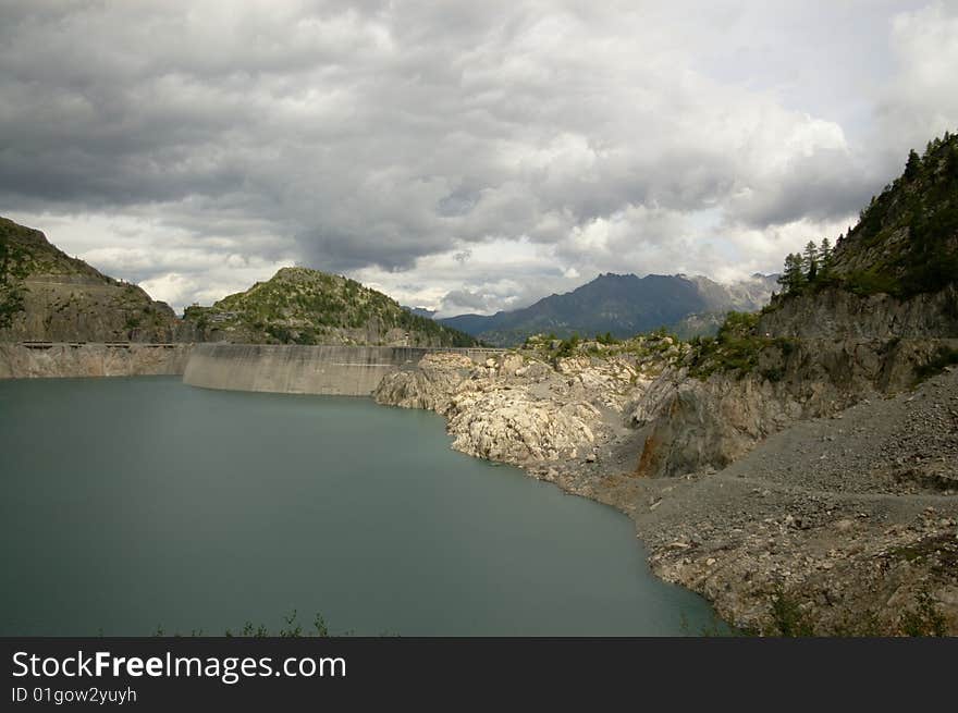 Panoramic view on swiss mountain lake with a huge dam, Switzerland. Panoramic view on swiss mountain lake with a huge dam, Switzerland