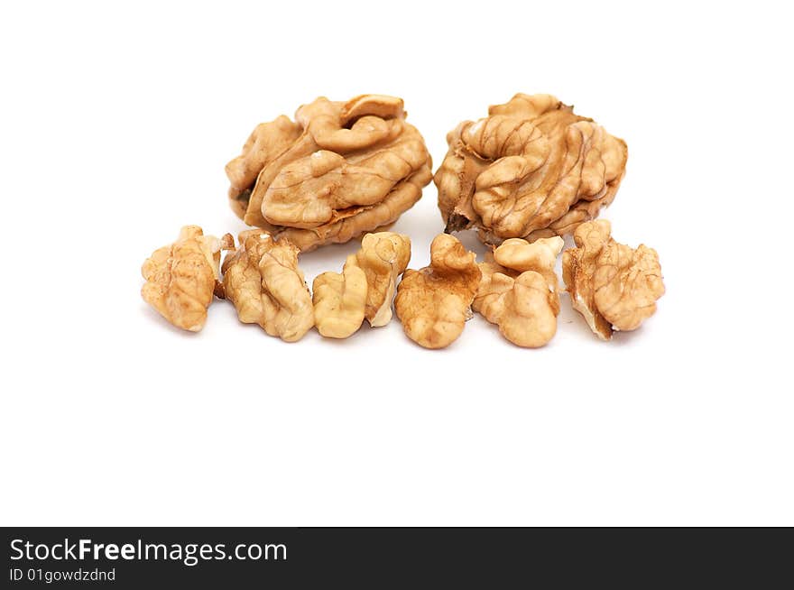 Pieces of walnuts on a white.