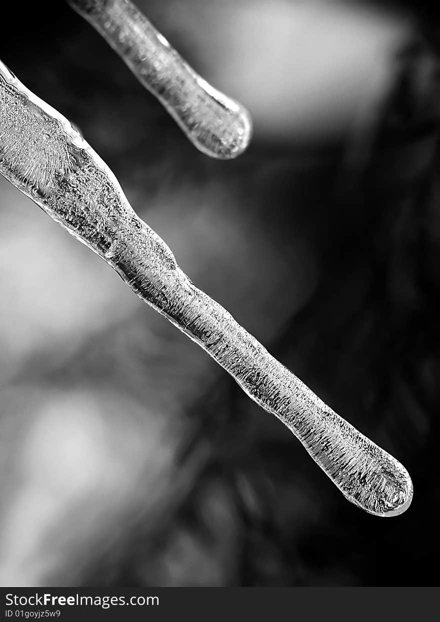 Icicles on black and grey background. Icicles on black and grey background